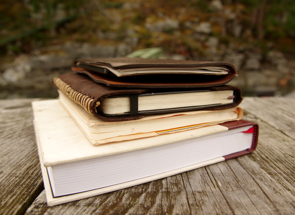 stack-of-notebooks-on-wooden-background.JPG